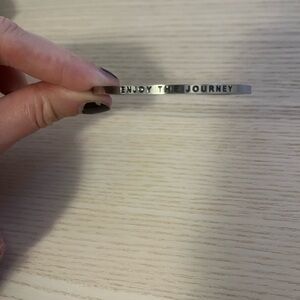 Silver bracelet with “enjoy the journey” engraved